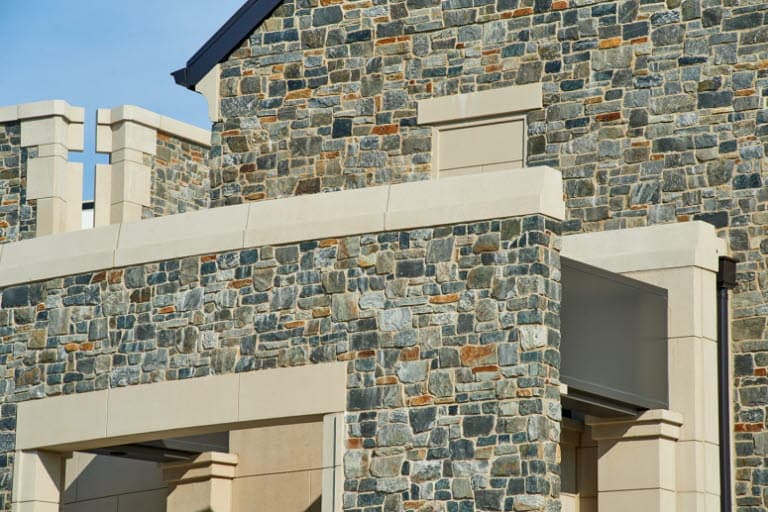 a close up view of a stone finish on a precast concrete building.