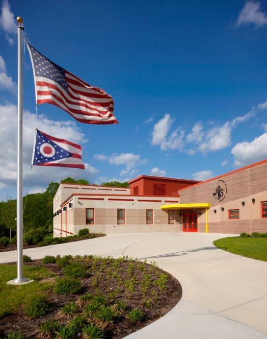 The world languages school with two flags on the lawn.