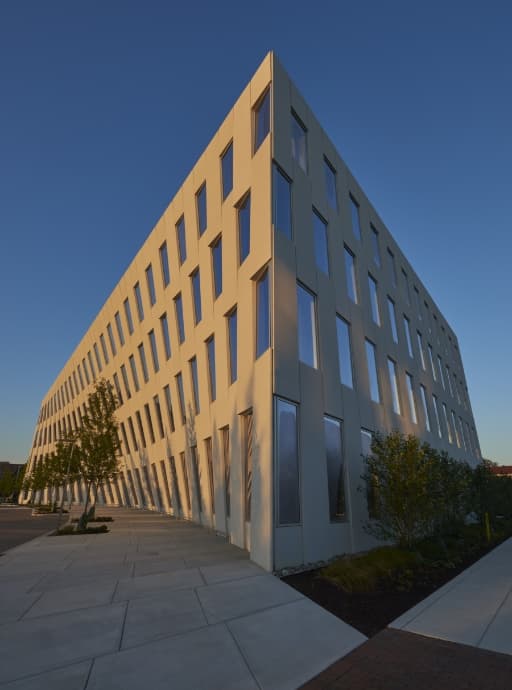 a precast concrete structure with a curved side and lots of windows.