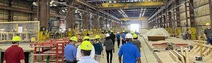 a group of people touring the precast plant