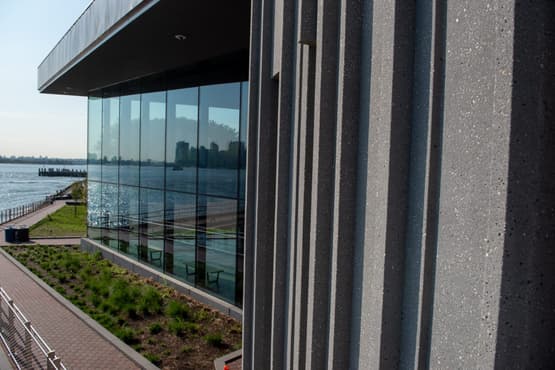 close view of a precast concrete building with vertical grooves in the design.